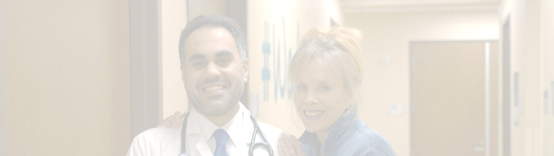 A doctor with a stethoscope around his neck stands next to a smiling woman in an RP clinic hallway, both looking at the camera. The image is faded and softly lit.