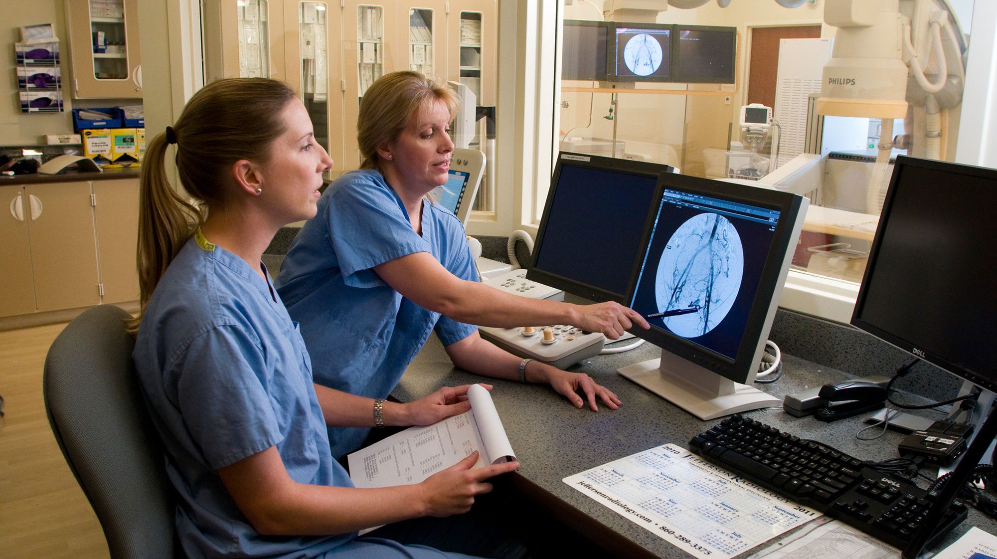 clinicians reviewing a radiology scan