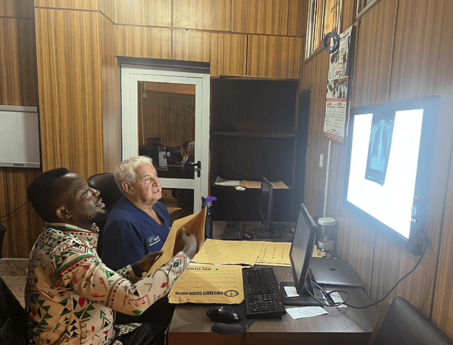two men reviewing a radiograph in a reading room